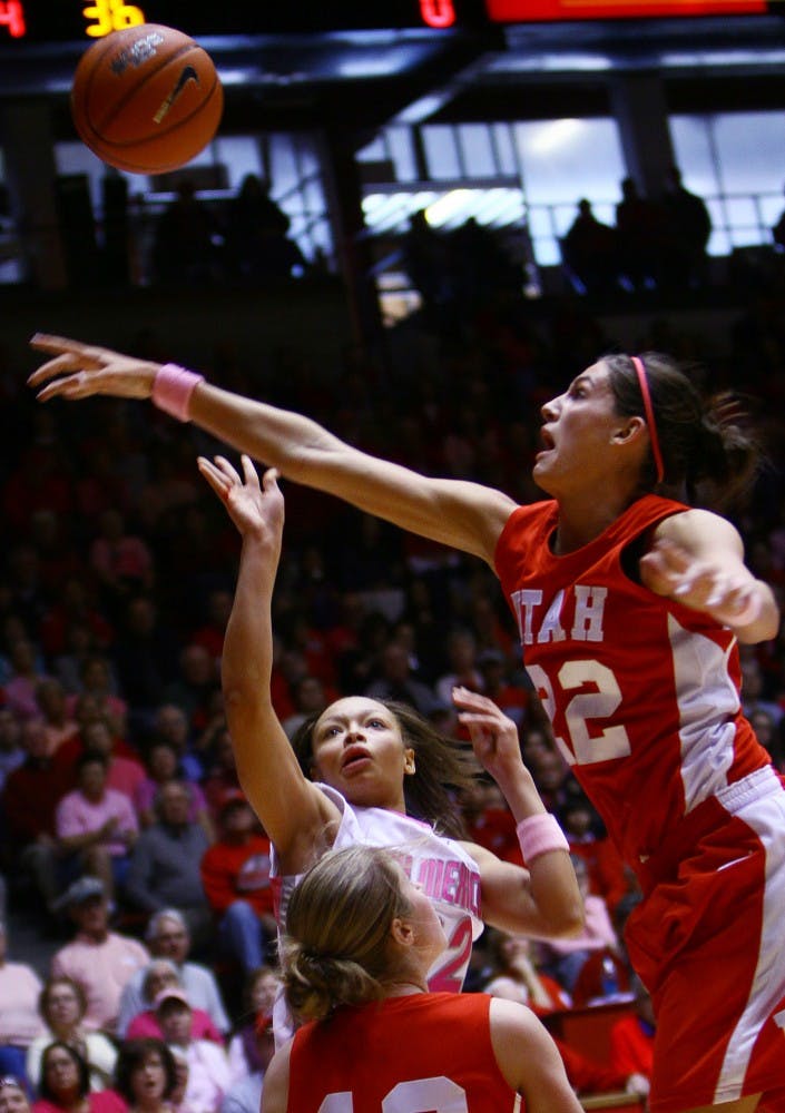 	Georonika Jackson gets swatted by Utah’s Halie Sawyer on Saturday at The Pit. Jackson heaved a desperate 3-pointer at the buzzer but missed the mark, and the Lobos lost 51-49 to the Utes.