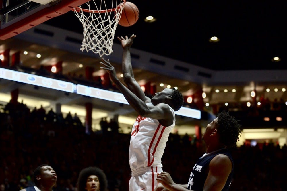 Junior center Obij Aget reaches past Utah State players for a rebound Saturday, Jan. 9 at WisePies Arena. The Lobos dropped their first Mountain West game of the season Tuesday night with an 86-74 loss at UNLV.