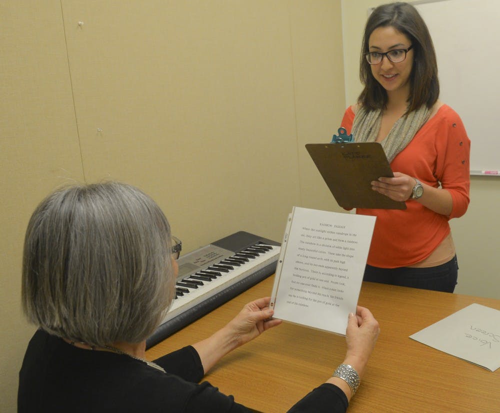 Kate Blaker, left, a speech- language clinic instructor,  trains SHS grad student Jennifer Romero for World Voice Day event. The UNM Speech and Hearing Science Department will host an event Friday where people can test their vocal health.