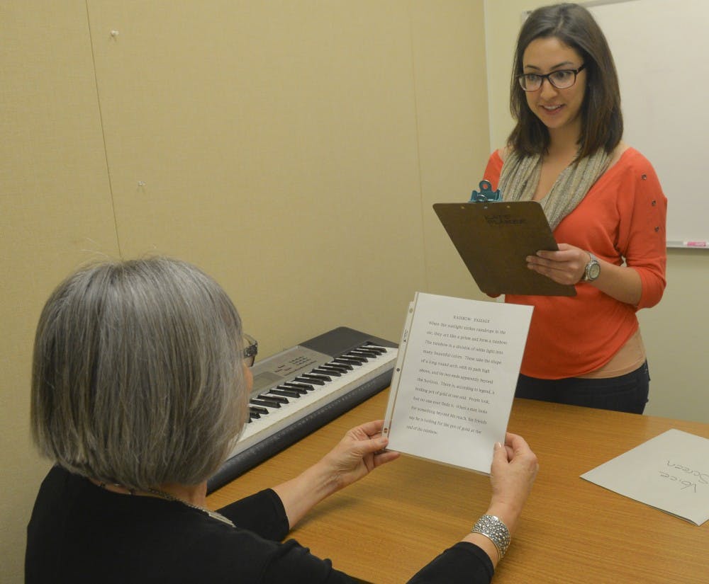 Kate Blaker, left, a speech- language clinic instructor,  trains SHS grad student Jennifer Romero for World Voice Day event. The UNM Speech and Hearing Science Department will host an event Friday where people can test their vocal health.
