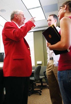 UNM President David Schmidly talks with ASUNM President Ashley Fate and Vice President Matthew Barnes during his first day of work on June 1 in Scholes Hall.  