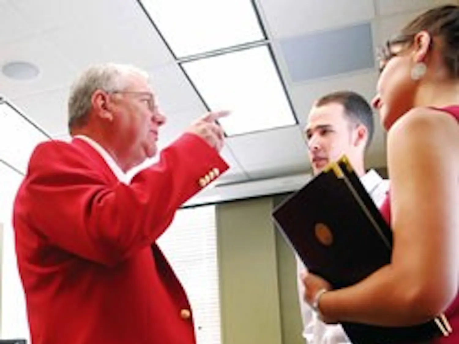 UNM President David Schmidly talks with ASUNM President Ashley Fate and Vice President Matthew Barnes during his first day of work on June 1 in Scholes Hall.