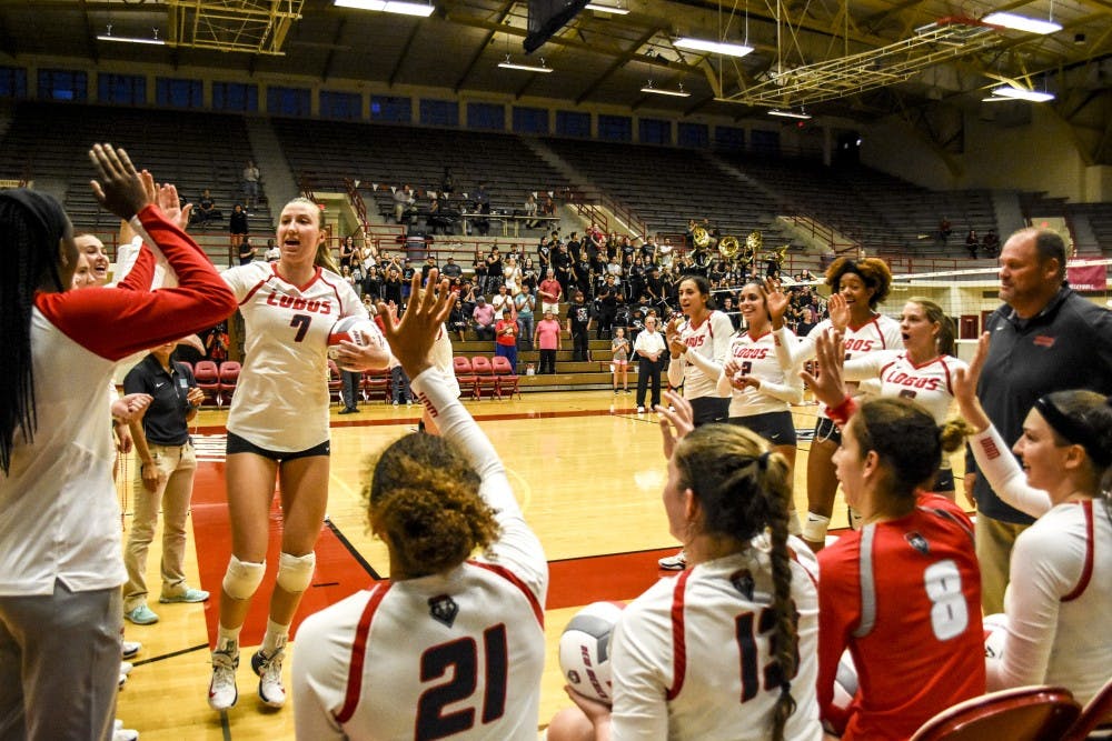 Junior Victoria Bragg, high fives a teammate on Aug. 8, 2017 at Johnson Gym during their game against the Portland Pilots. UNM defeated the Pilots 3-2.