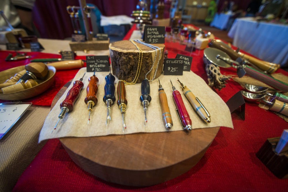 Gail Tate and Nadine Williams of Wooden It Be Nice have their products set up at the 53rd ASUNM Arts and Crafts Fair on Wednesday, at the UNM SUB Ballrooms. The fair lasts through Friday and features dozens of local artists.