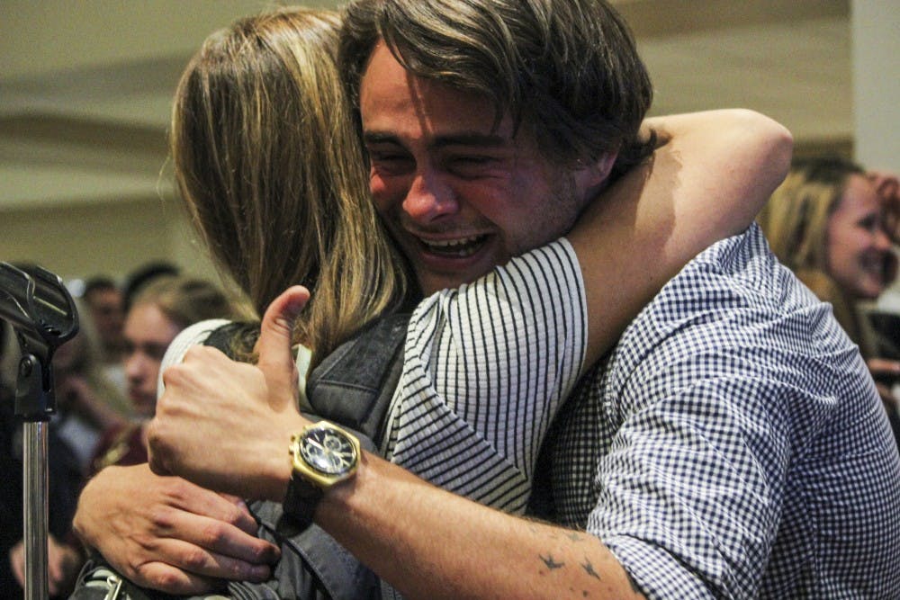 ASUNM Senator Theo Pirone-Aufrichtig embraces a friend after learning the 2017 ASUNM Senate Election results.&nbsp;