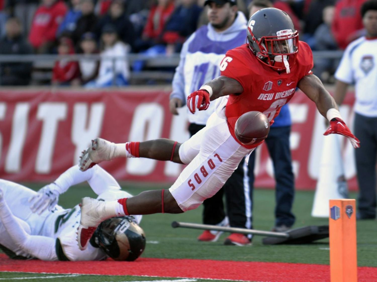 Redshirt senior Jhurell Pressley leaps into the end zone as the ball slips from his fingers at University Stadium Nov. 21. The Lobos seniors played a pivitol role in securing UNM's first bowl game since 2007. 