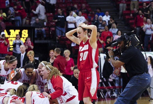 Sara Halasz walks off the court Friday as Utah celebrates its win over UNM in the Mountain West Conference semifinals in Las Vegas, Nev.