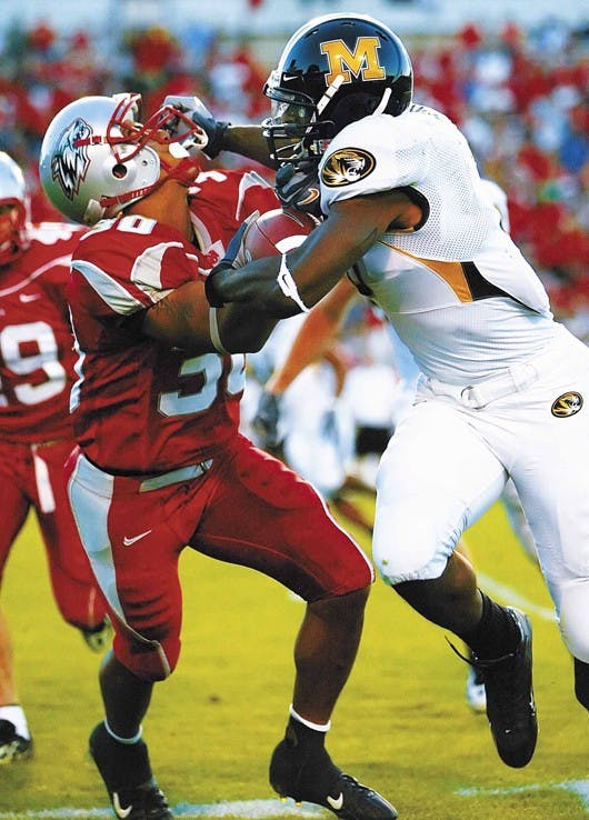 Missouri's Will Franklin, right, facemasks Lobo freshman cornerback Ian Clark during the Lobos' 27-17 loss Saturday at University Stadium.