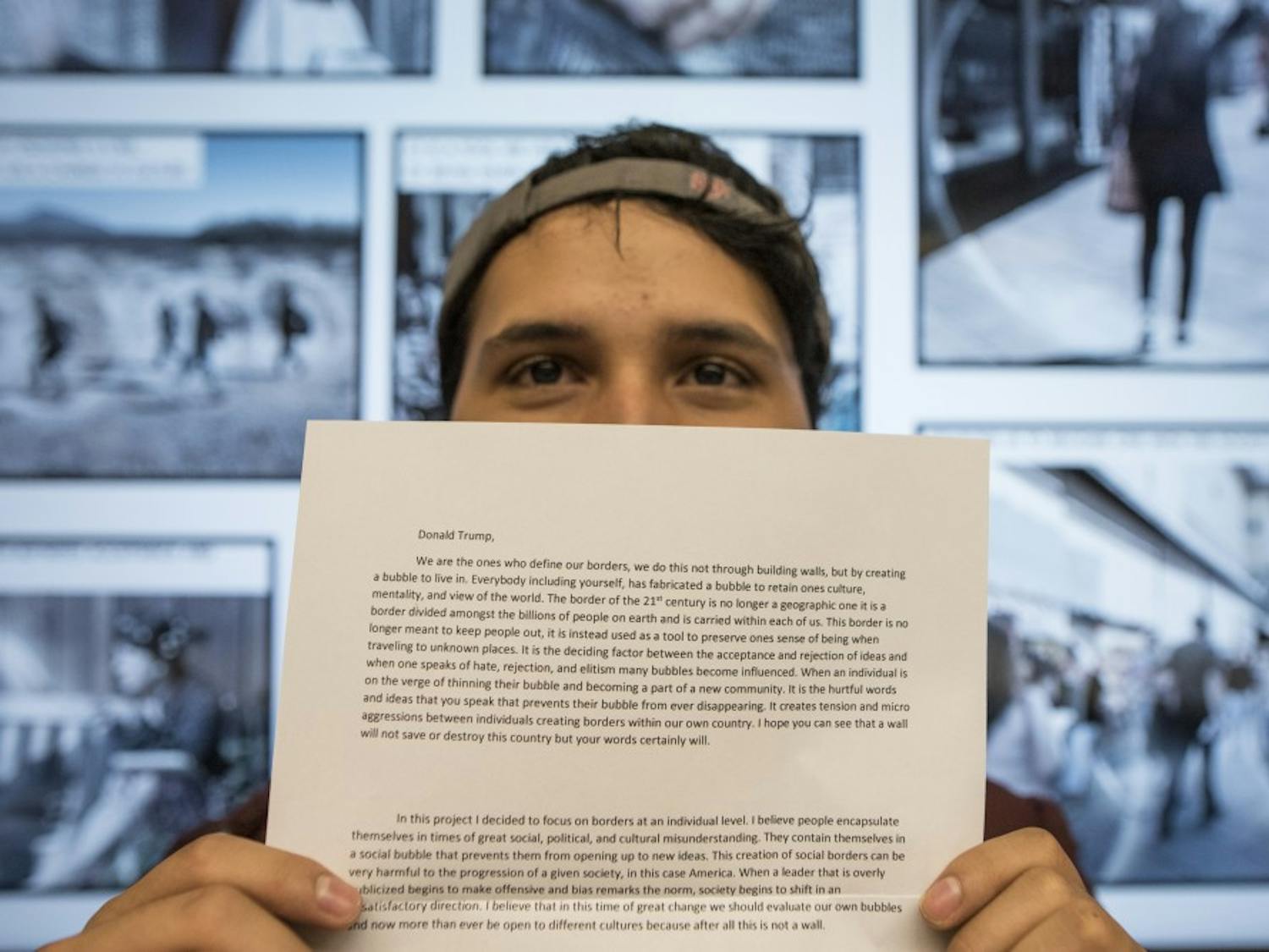 A UNM Architecture and Planning students stands in front of his proposed boarder wall while holding a letter to President Donald Trump Wednesday, April 26, 2017 at George Pearl Hall. Students where tasked with designing their own rendition of a United States Mexico boarder wall and to write a letter to Trump critiquing current policies.