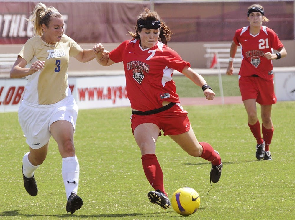 	Alexis Ball fends off Tulsa midfielder Emily McElrath on Sunday at the UNM Soccer Complex. The Lobos and Golden Hurricane tied, putting the Lobos at 6-0-1 for the season.