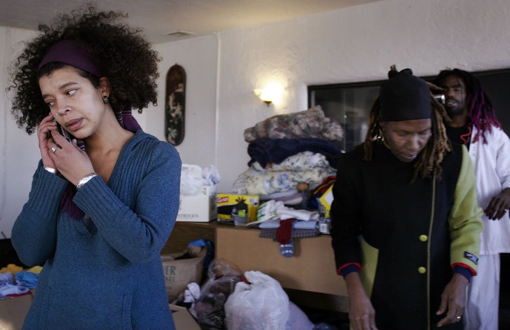 	Cecelia Westman, left, takes a call while Maggie Doerrer and Greg Mitton sort donated goods Tuesday for their trip to Haiti. Doerrer and Mitton said they plan to leave Thursday. 