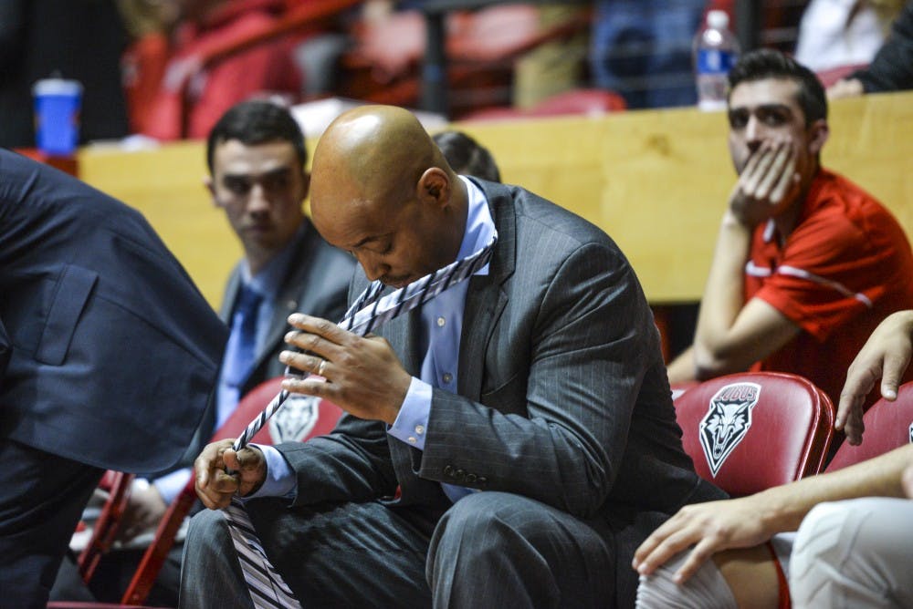 Assistant Lobo coach Terrence Rencher takes off his tie with two seconds left on the game clock during their game against UNLV Tuesday, Jan. 10, 2016 at WisePies Arena. The Lobos lost to the Rebels 71-66.&nbsp;