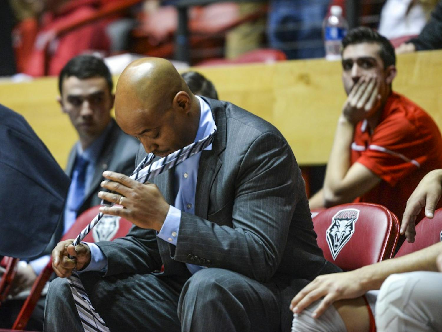 Assistant Lobo coach Terrence Rencher takes off his tie with two seconds left on the game clock during their game against UNLV Tuesday, Jan. 10, 2016 at WisePies Arena. The Lobos lost to the Rebels 71-66.&nbsp;