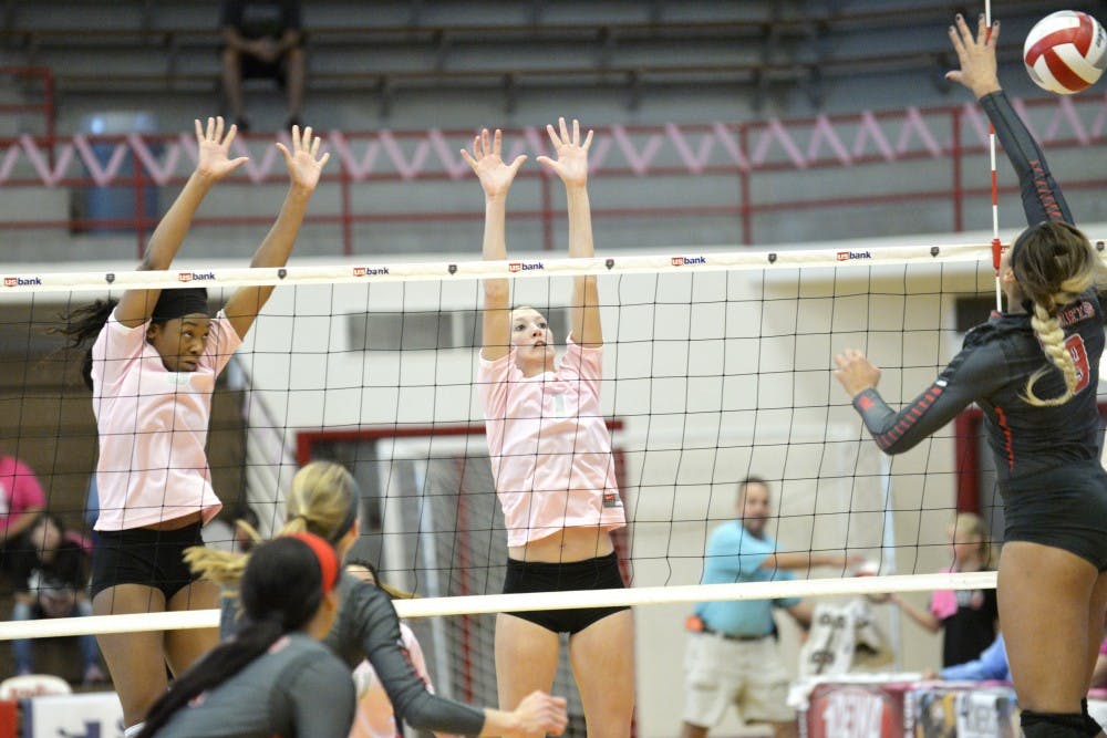 Middle blocker Simone Henderson (left) and Devanne Sours attempt to block a UNLV attack at Johnson Center Saturday, Oct. 17, 2015. The Lobos face off with Air Force Tuesday night at Johnson Center.&nbsp;
