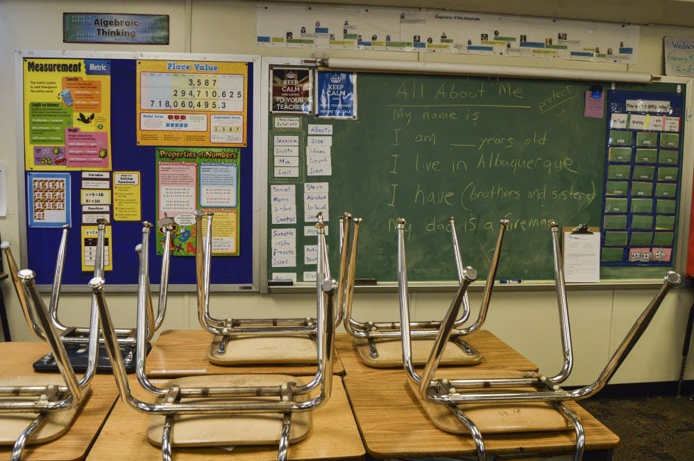 Chairs lay on top of desks in a empty class room at Lavaland Elementary School.