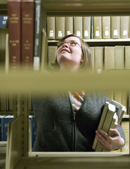 Megan Beard files books in Zimmerman Library's basement Tuesday.