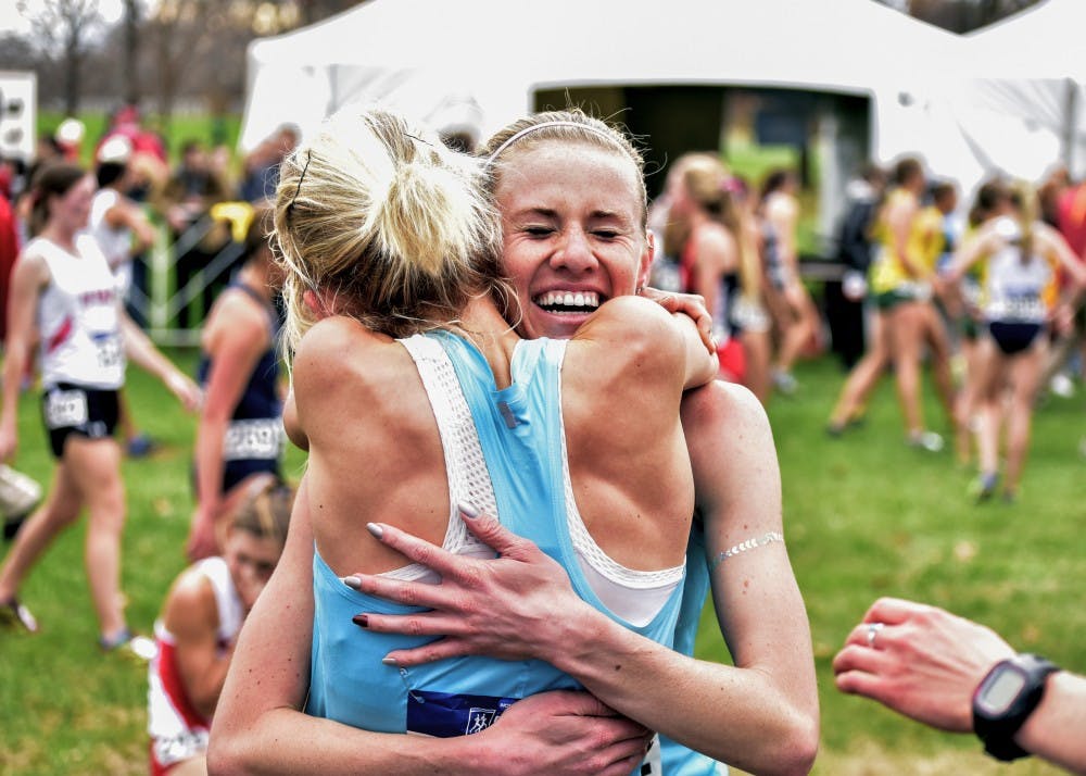 Senior Courtney Frerichs is embraced by one of her teammates after crossing the finish line at the NCAA Division I Cross Country Championships on Saturday, Nov. 21 in Louisville, KY. Frerichs was the first Lobo to cross the finish line, coming in 4th place to help UNM win its second ever national title.