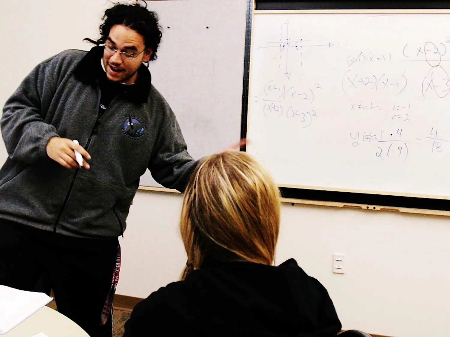 Juan Ortiz, a tutor with Student Support Services, helps Alexia Carter graph equations during the first day of Blast Off to Finals in the SUB on Monday. The week-long event offers free tutoring in math and English, massages from Apollo College students, a