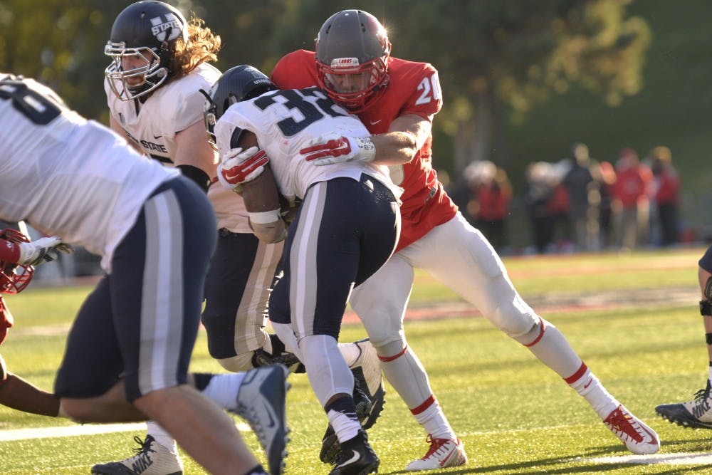 Senior linebacker Ryan Langford takes down Utah State running back Devante Mays at University Stadium Saturday afternoon. The Lobos defense helped New Mexico to a 14-13 victory over the Aggies.&nbsp;