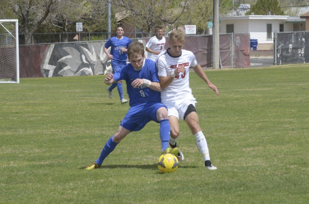 UNM freshman forward/midfielder Sam Gleadle tries to steal the ball from Air Forces Ryan Ward on Saturday afternoon at Robertson Field. The Lobos defeated the Falcons 2-1 in overtime.

