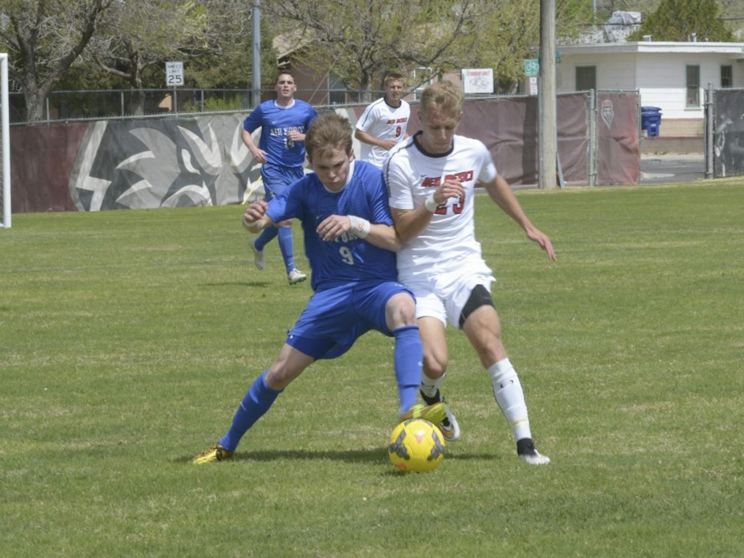 UNM freshman forward/midfielder Sam Gleadle tries to steal the ball from Air Forces Ryan Ward on Saturday afternoon at Robertson Field. The Lobos defeated the Falcons 2-1 in overtime.