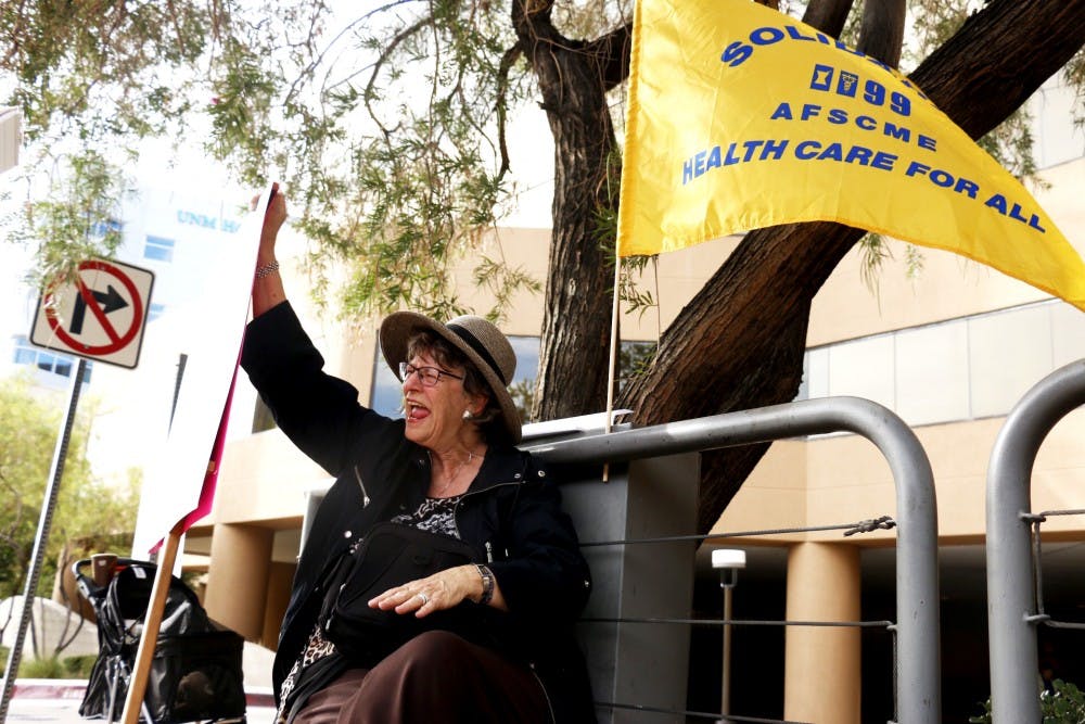 A protestor yells at traffic that passes by in front of the University of New Mexico Hospital Wednesday Sept. 28, 2016. The UNM&nbsp;Hospital Labor coalition sponsored the event in hopes to raise awareness about wages at the hospital.&nbsp;