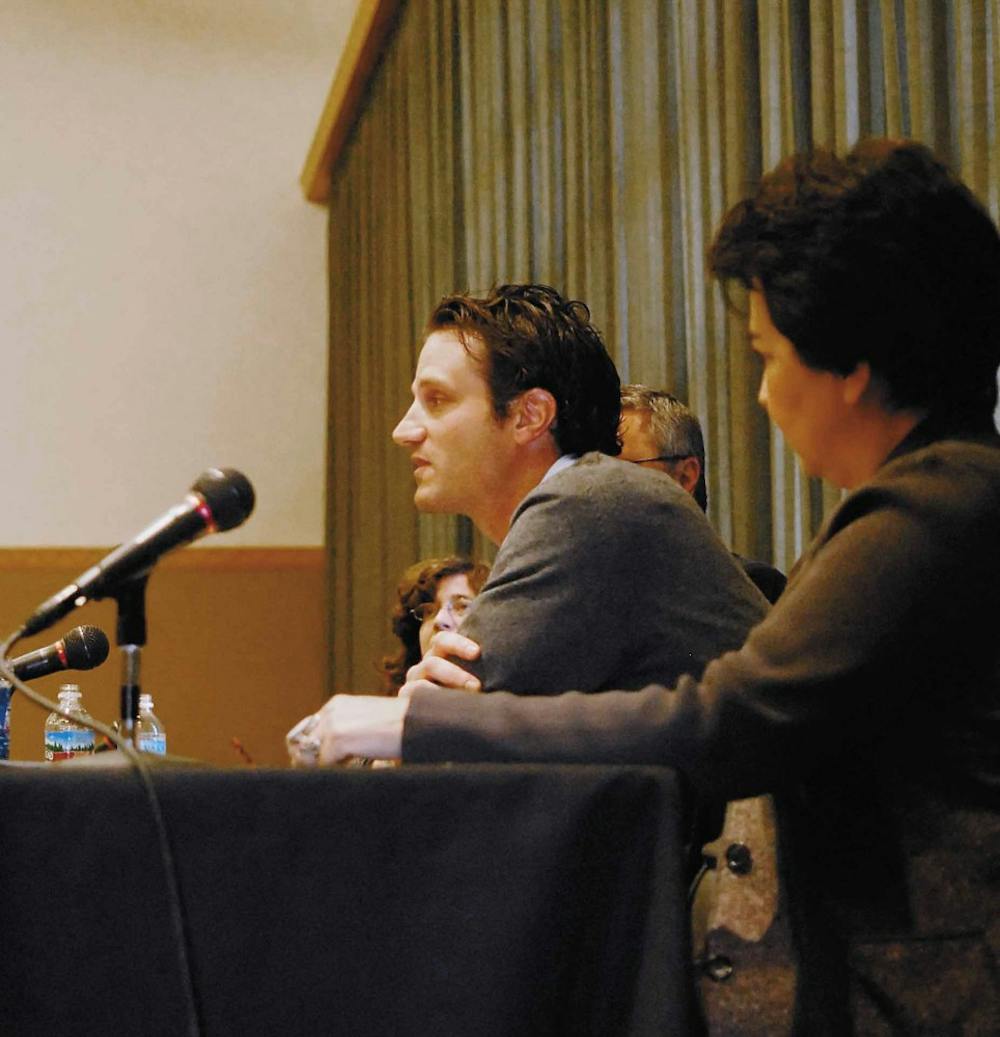 Christine Sierra listens to Michael Rocca explain his views on Congress during a panel discussion about the war in Iraq on Friday in the SUB.