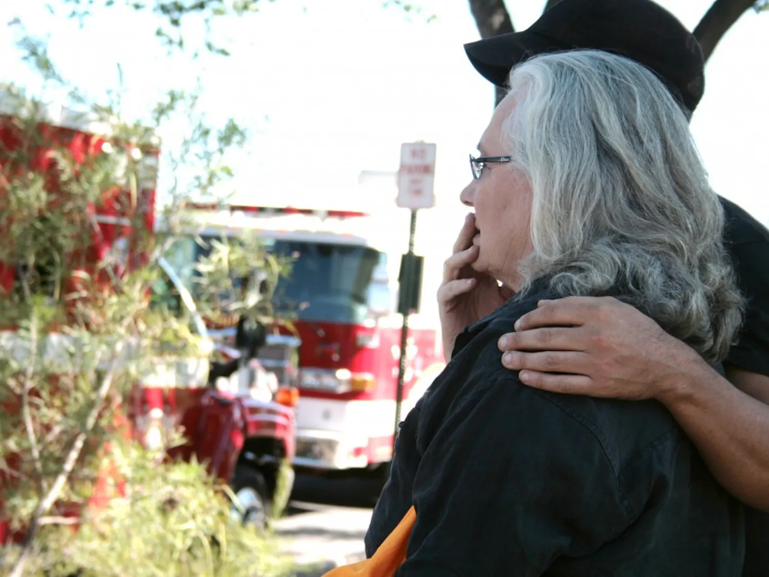 The landlady of a fourplex house looks on in shock as re ghts work to put out a residential re at the corner of Cornell Drive and Lead Avenue.