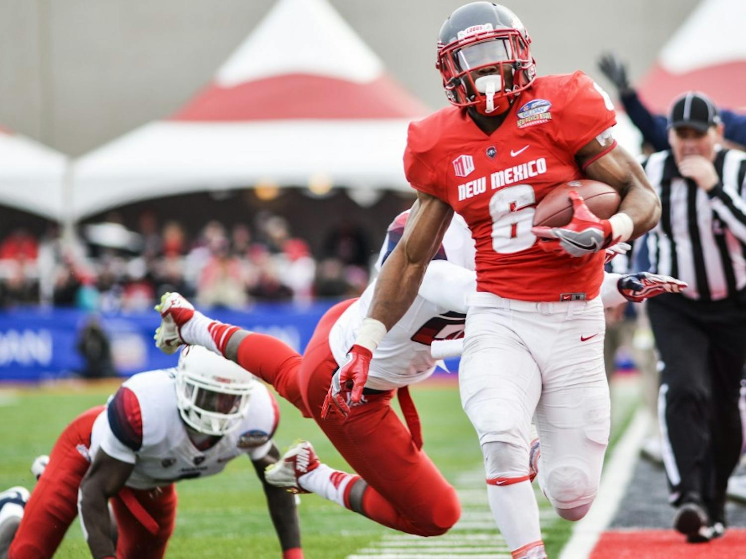 UNM’s Jhurell Pressley evades Arizona University defensemen during the 10th Gildan New Mexico Bowl Saturday December 19, 2016 at University Stadium. Pressley will try his chances in becoming a free agent for the Minnesota Vikings.