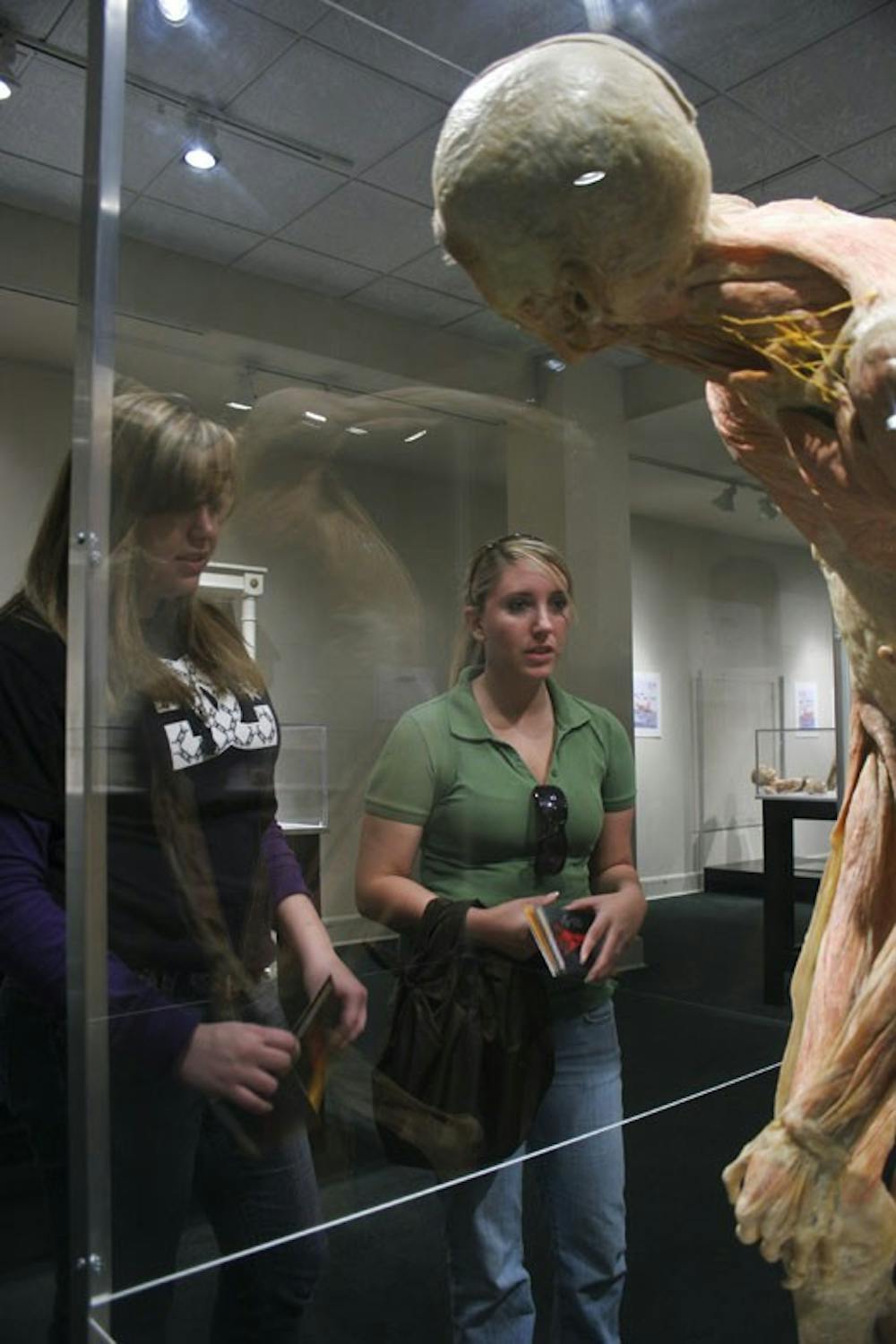 Student Sara Nevarez, left, and Kasey Snow look at a plasticized human corpse during the Bodies Human Exhibit at Coronado Center on Tuesday. A group of UNM medical students plan to protest the exhibit Saturday because they say it's unethical.