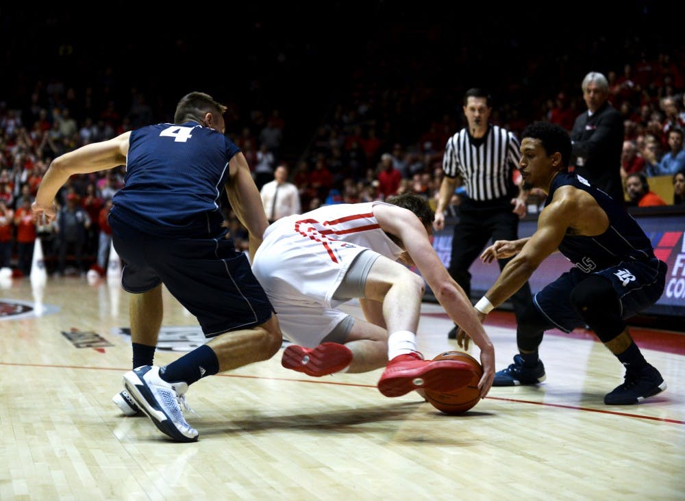 Redshirt sophomore guard Cullen Neal falls for the ball against two Rice players at WisePies Arena Dec. 19. The Lobos lost three out of three games in the Hawaiin Airlines Diamond Head Classic and will play Nevada this Wednesday at 7 p.m..