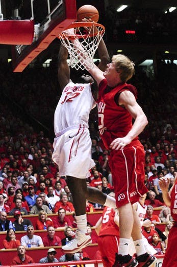 Tony Danridge dunks over 7-feet-2-inch Luke Nevill during Tuesday's win over Utah. Danridge had a career-high 29 points in his final game at The Pit, leading the Lobos to a 77-71 victory over the Utes.
