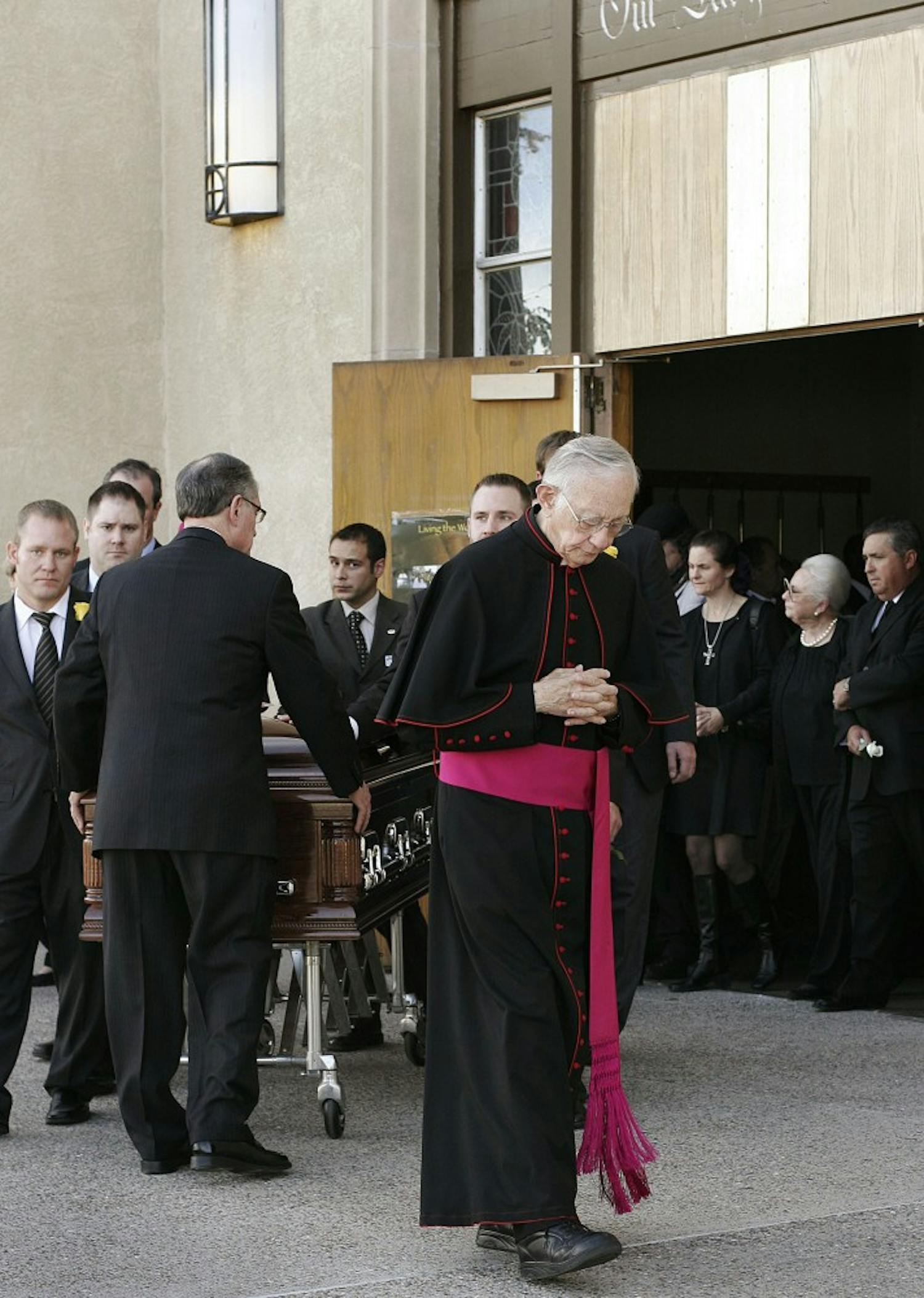	Monsignor Francis X. Eggert leads the procession carrying Justice Gene Franchini’s casket at Our Lady of Fatima Catholic Church on Saturday. Franchini died Wednesday evening while giving a speech to first-year law students on north campus. Over 500 people attended Franchini’s funeral, including Board of Regents President Raymond Sanchez, a long-time friend.