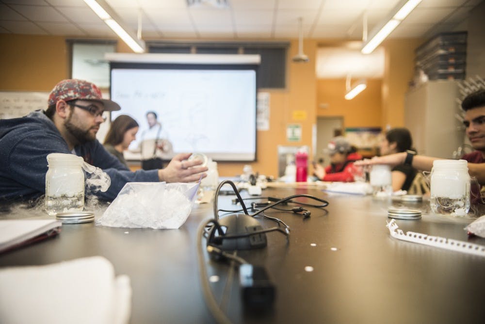 Mason jars fill with dry ice, water bubbles and steam while professor Mel Strong teaches students how clouds form and how to implement it into their science experiments on Tuesday, Jan. 31, 2017.