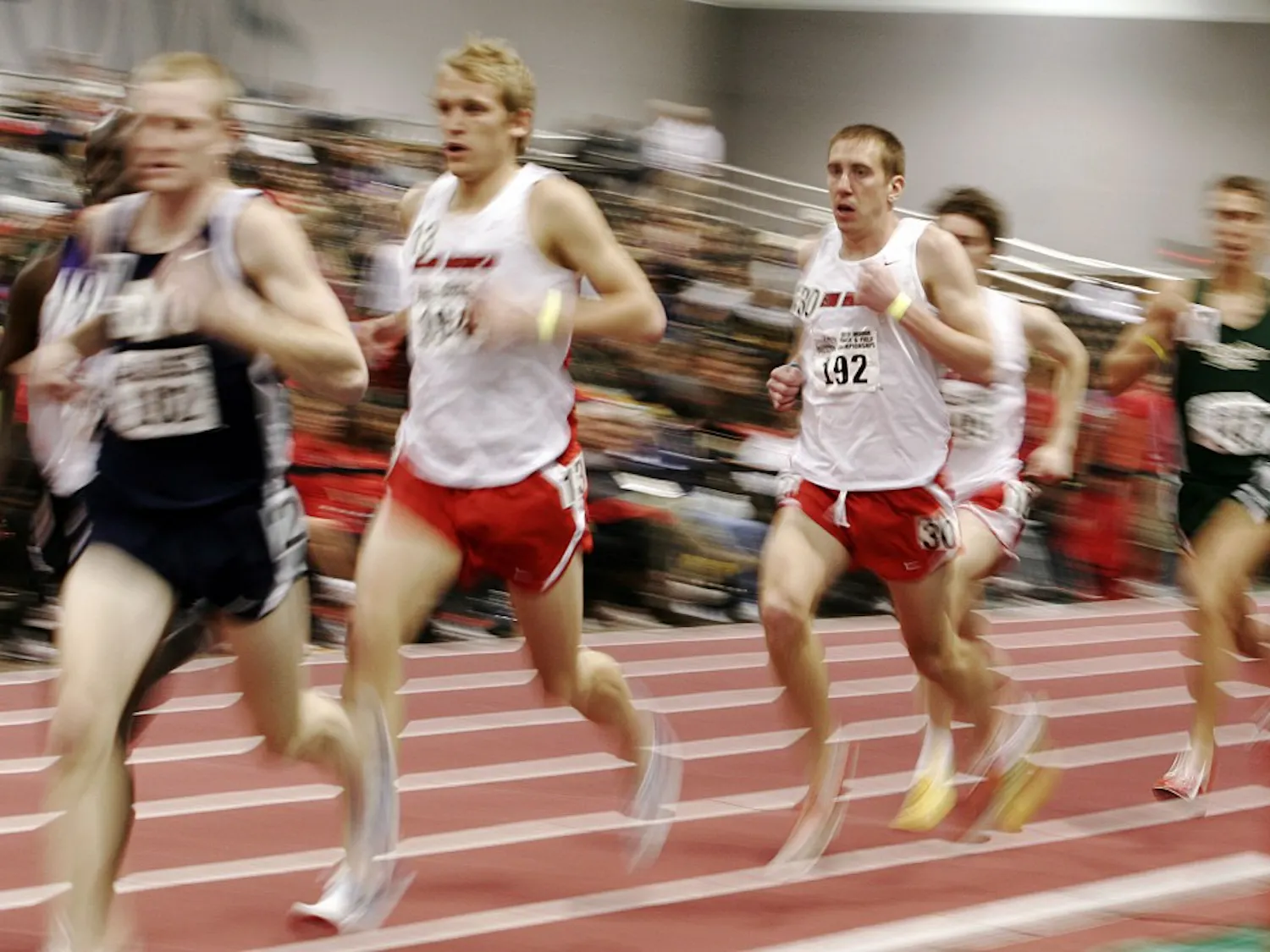Lee Emanuel, center, drifts during the 3,000-meter run at the Albuquerque Convention Center on Saturday. Emanuel dropped out of the 3,000-meter midway through. Emanuel won two events, including the mile run, and looks to defend his NCAA championship in two weeks at the NCAA Preliminary Round.