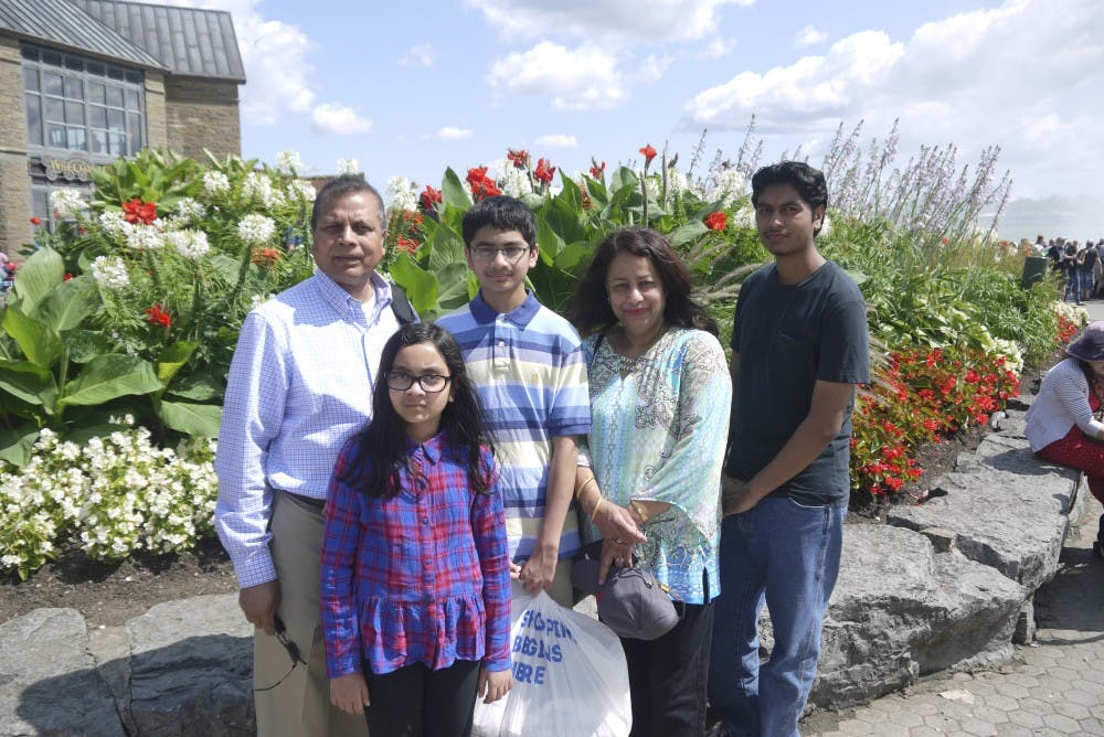 Photo courtesy of&nbsp;Ziarat Hossain, Ph.D.Ziarat Hossain, Ph.D. (left) poses with his family.