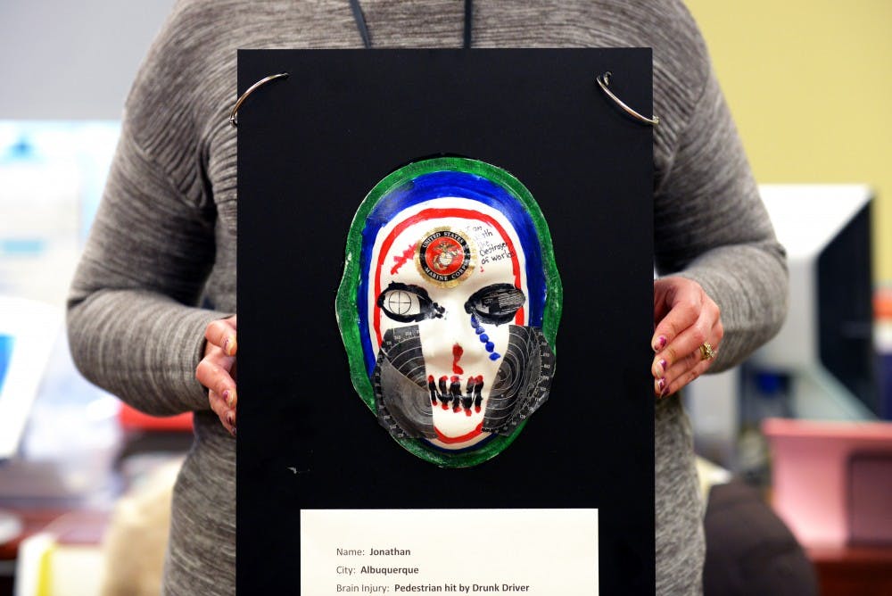 Janelle Torres-Groover holds one of the injury mask at&nbsp;the Center of Debilitation on  Feb. 25, 2016. The mask are made as therapeutical tools; this&nbsp;mask was made by Jonathan, one of the patients in the center.