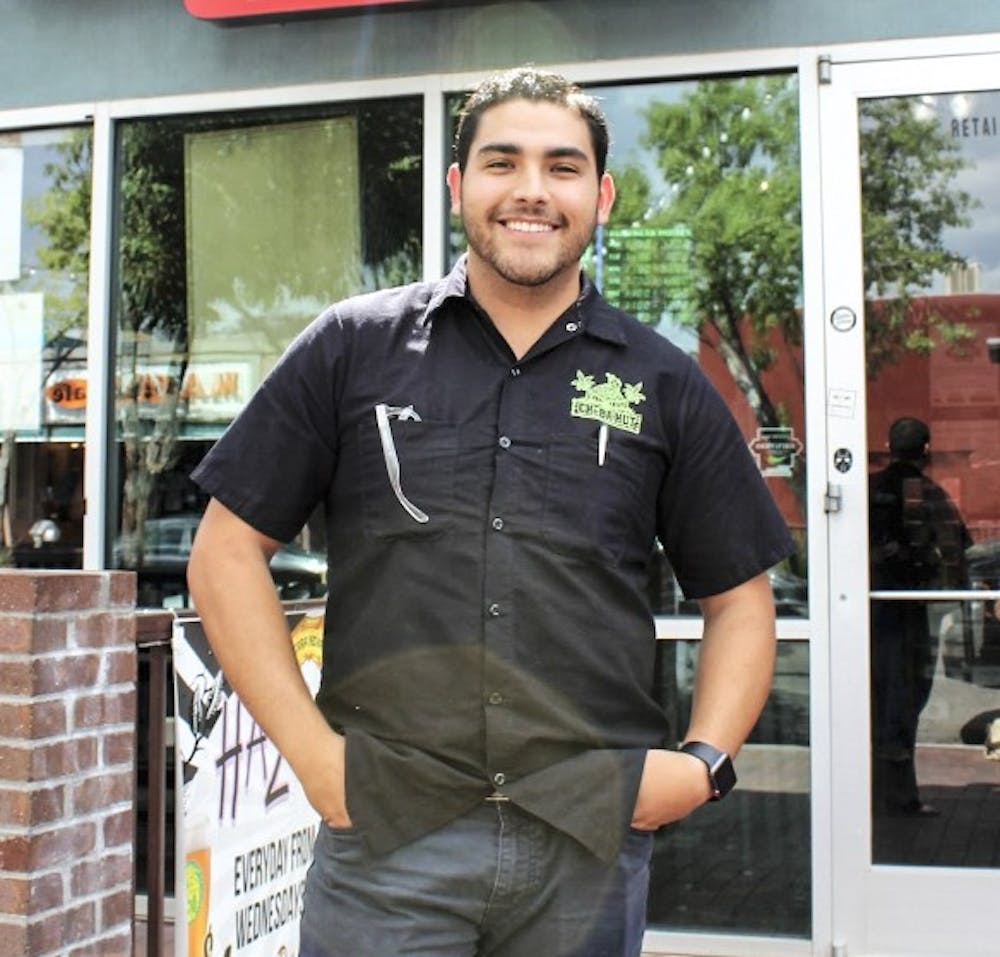 Isaac Montoya poses for a reporter outside of the sandwich shop Cheba Hut.