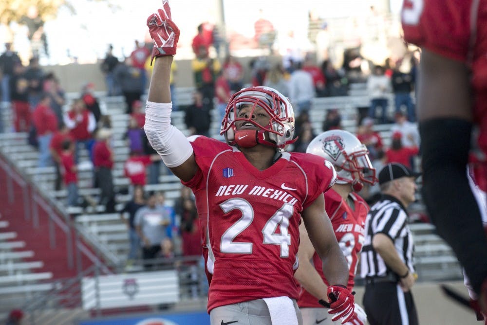 New Mexico wide receiver Carlos Wiggins celebrates after scoring the touchdown that gave the Lobos the lead during the game against Wyoming on Saturday. Wigginsâ€™ 97 yards kickoff return for the touchdown was the fourth of his career, a school and Mountain West record.