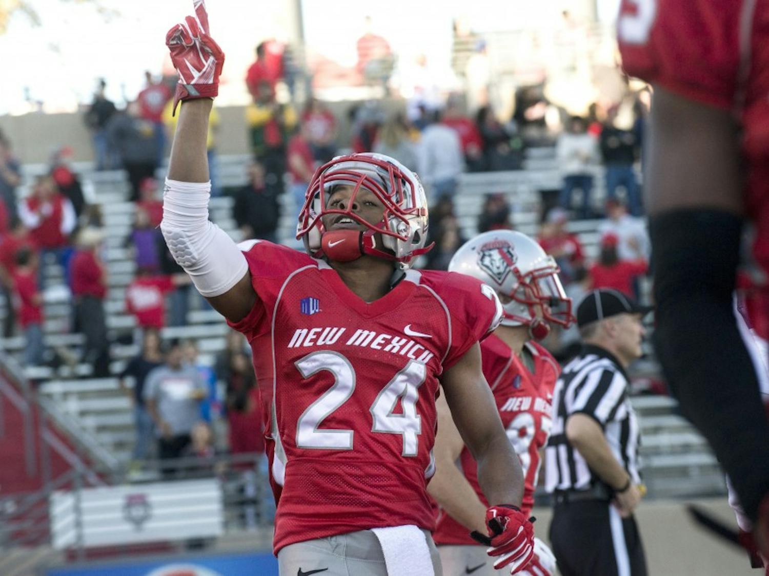 New Mexico wide receiver Carlos Wiggins celebrates after scoring the touchdown that gave the Lobos the lead during the game against Wyoming on Saturday. Wigginsâ€™ 97 yards kickoff return for the touchdown was the fourth of his career, a school and Mountain West record.