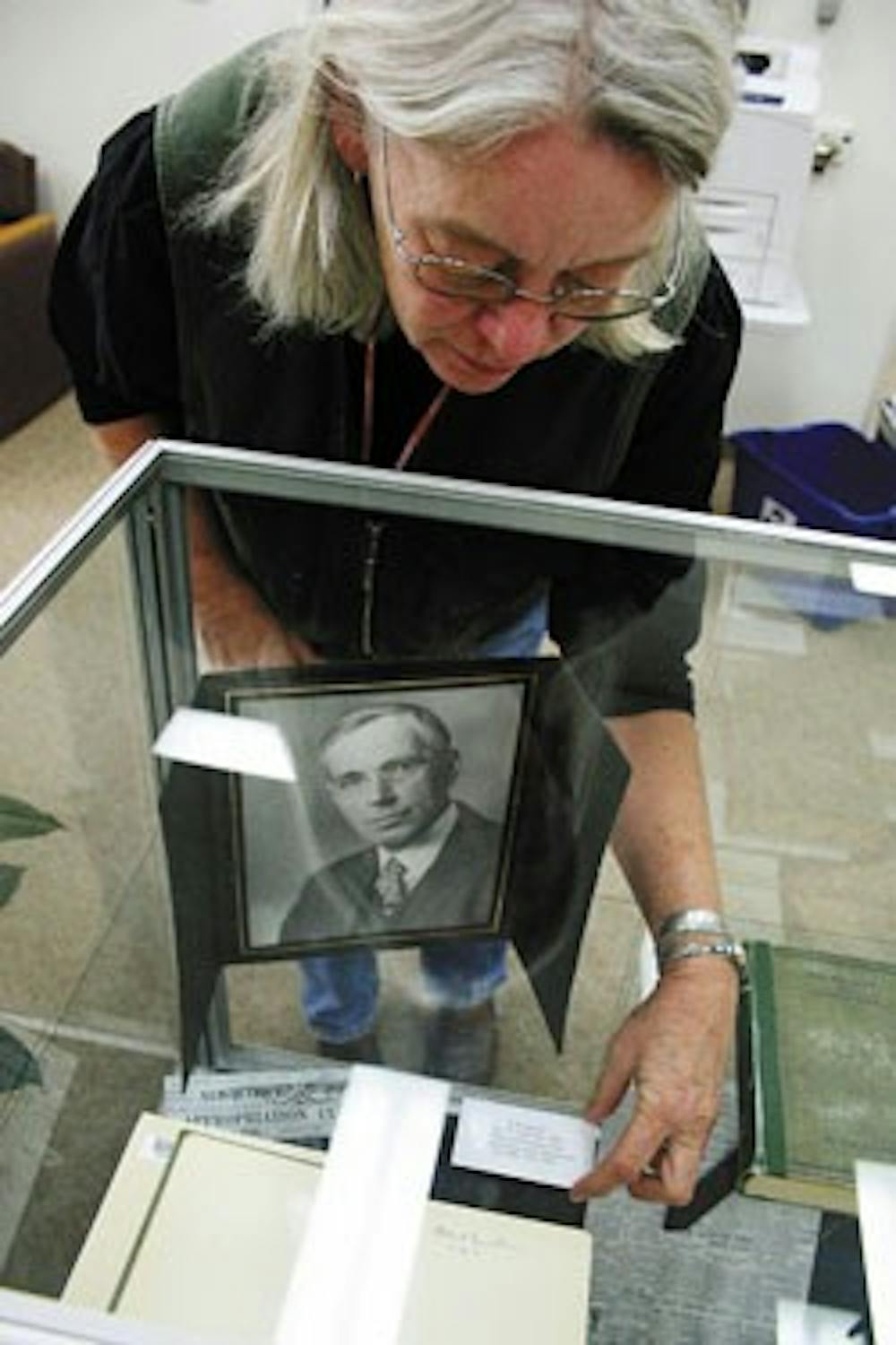 Centennial Science and Engineering Library employee Kash Heitkamp on Nov. 20 adjusts the display of F.M. Denton's Relativity and Common Sense, signed by Albert Einstein. The book was recently donated to UNM along with a collection of correspondence betwee