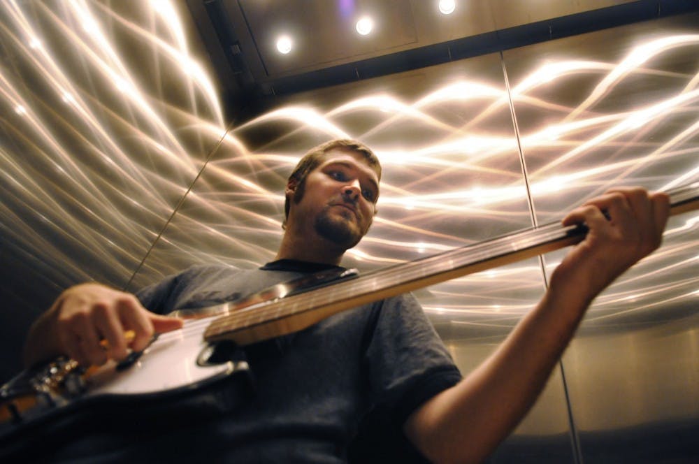 	Student Alex Langston, who calls himself Mud Octave in his solo project, settles into a groove in one of the architecture building’s elevators. 