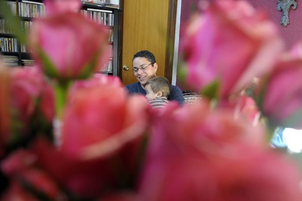 Tanya Cole, owner of Tiger Lilly Flowers, with her son in her house on Wednesday.