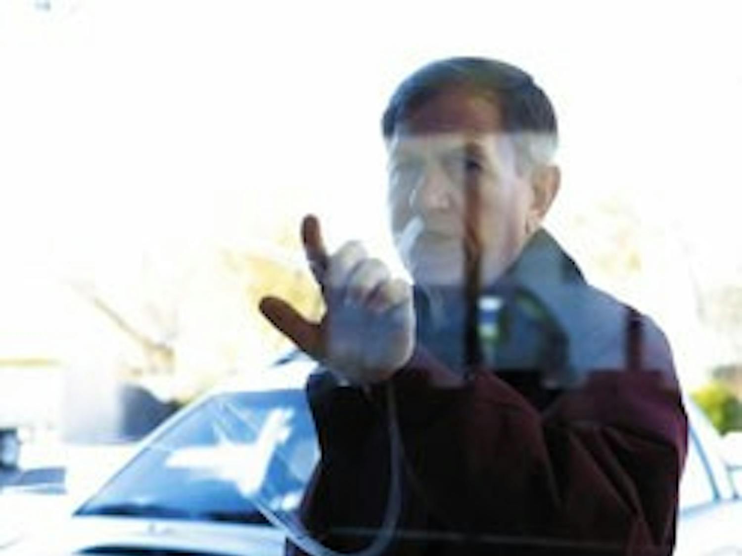 Morgan Patterson, director of community relations and development for the Salvation Army, looks at graffiti on a window outside of the donation drop-off on Central Avenue on Wednesday.