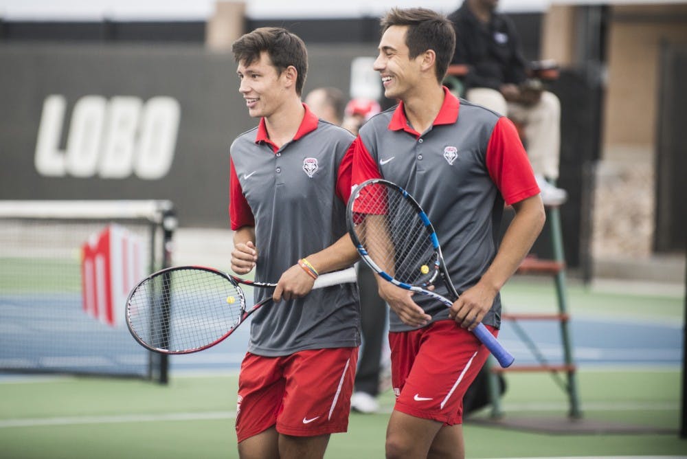 Freshman Ricky Hernandez-Tong, left, and sophomore Jorge Escutia laugh as they walk off the court after a doubles match on Sunday April 17, 2016. The Lobos will play Denver University this Sunday at 2 p.m.