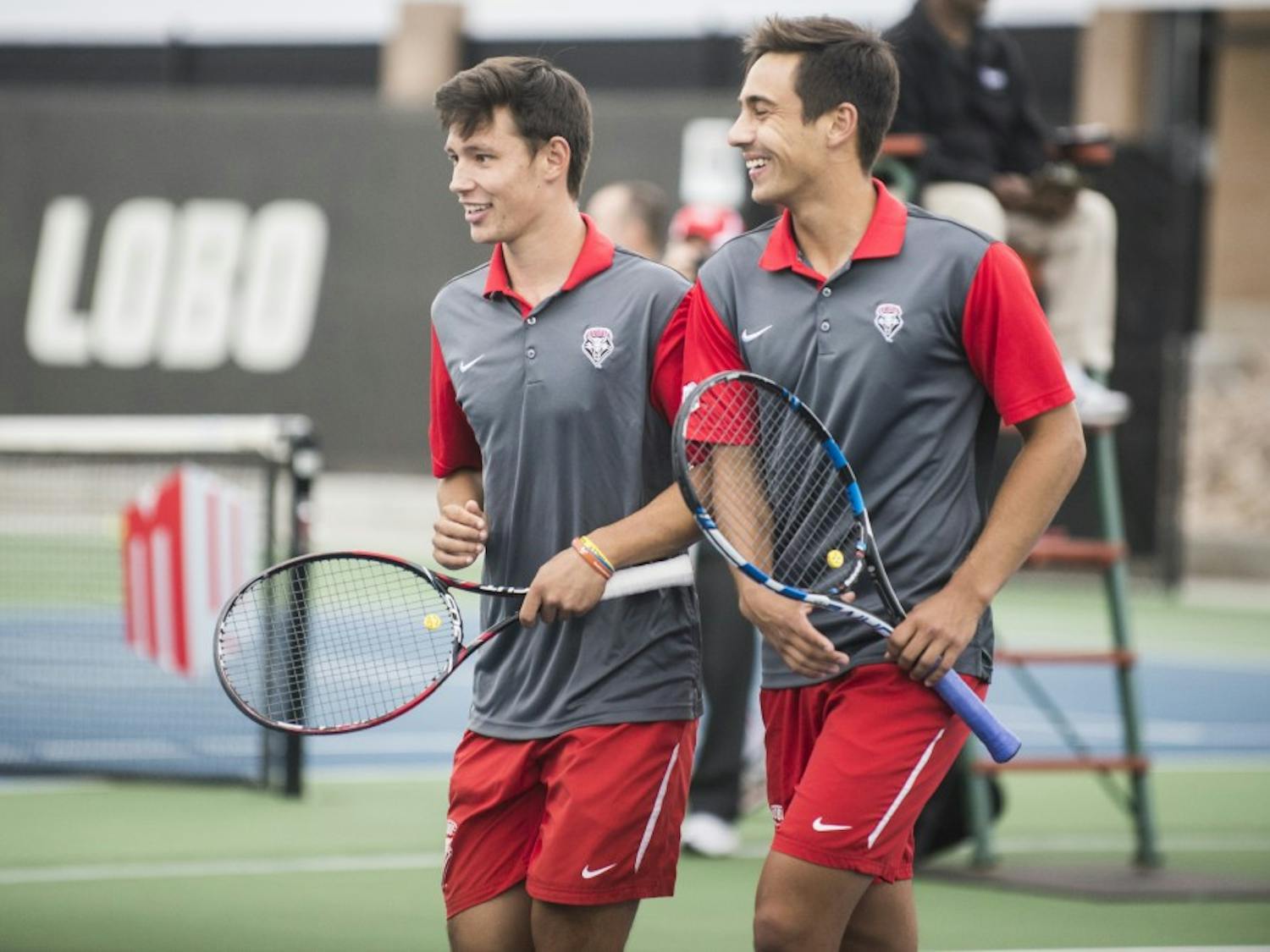 Freshman Ricky Hernandez-Tong, left, and sophomore Jorge Escutia laugh as they walk off the court after a doubles match on Sunday April 17, 2016. The Lobos will play Denver University this Sunday at 2 p.m.