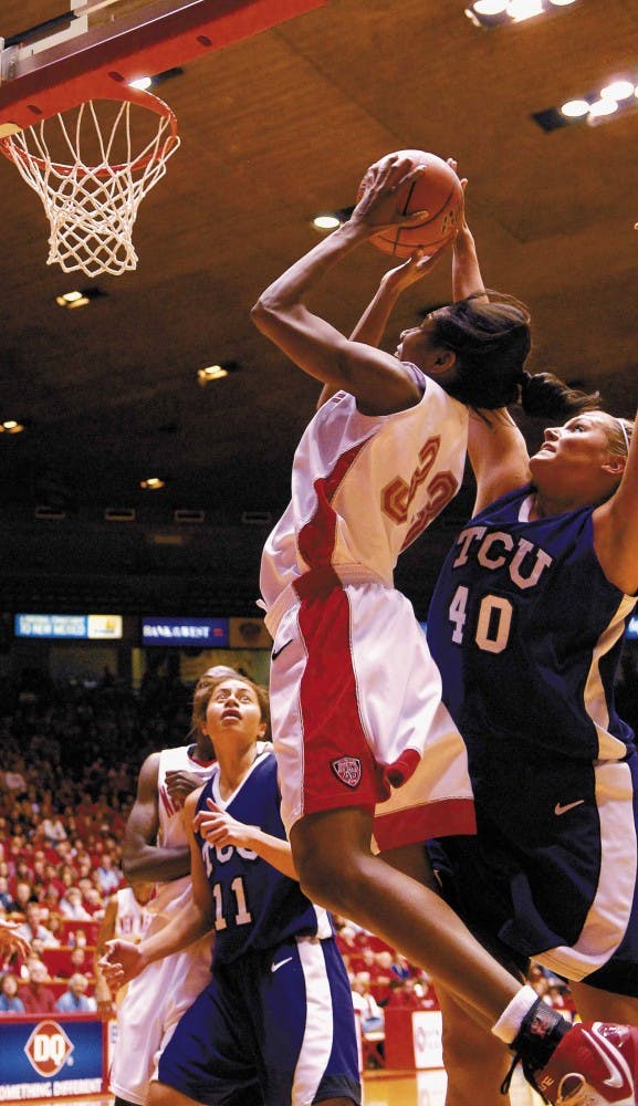 Forward Dionne Marsh shoots while Texas Christian's Jenna Lohse defends during the second half of Sunday's game at The Pit. The Lobos won 75-54.