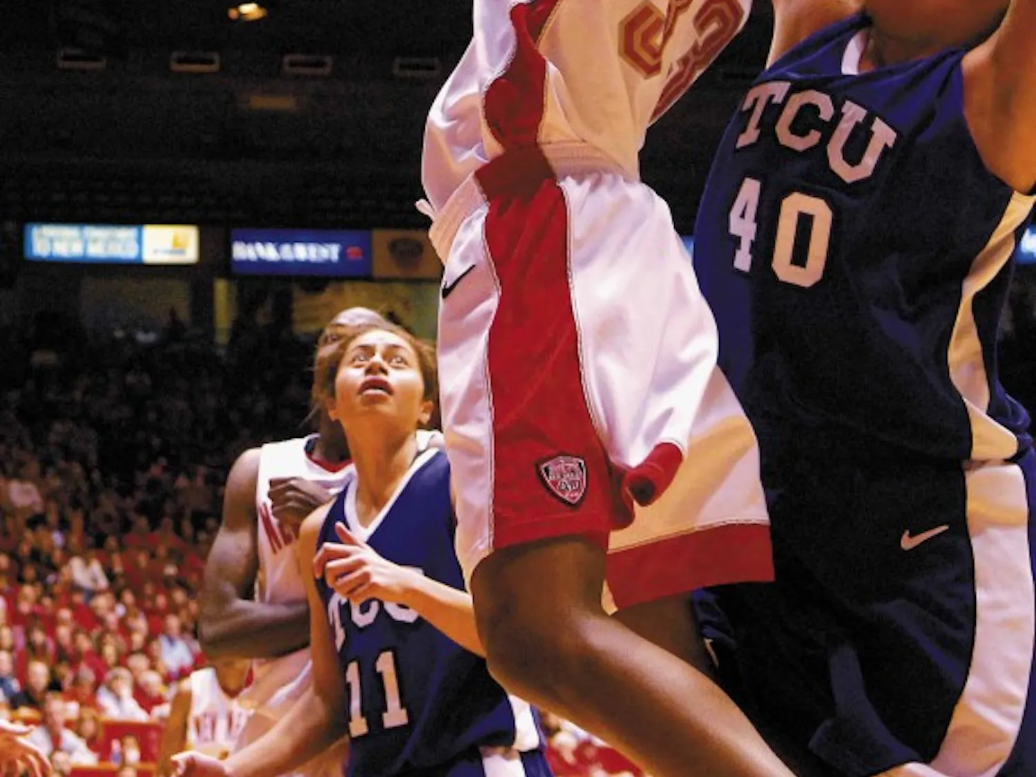 Forward Dionne Marsh shoots while Texas Christian's Jenna Lohse defends during the second half of Sunday's game at The Pit. The Lobos won 75-54.