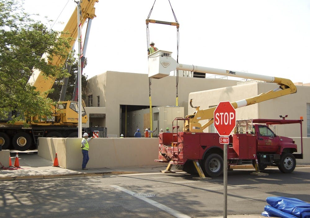 	A construction crew installs a new turbine at the Ford Utility Center Saturday morning.  The new turbine generates electricity, and then recaptures and uses “waste” steam to heat and cool buildings. The new turbine will be about 75 to 80 percent efficient while most other power plants are only about 30 to 40 percent efficient. 