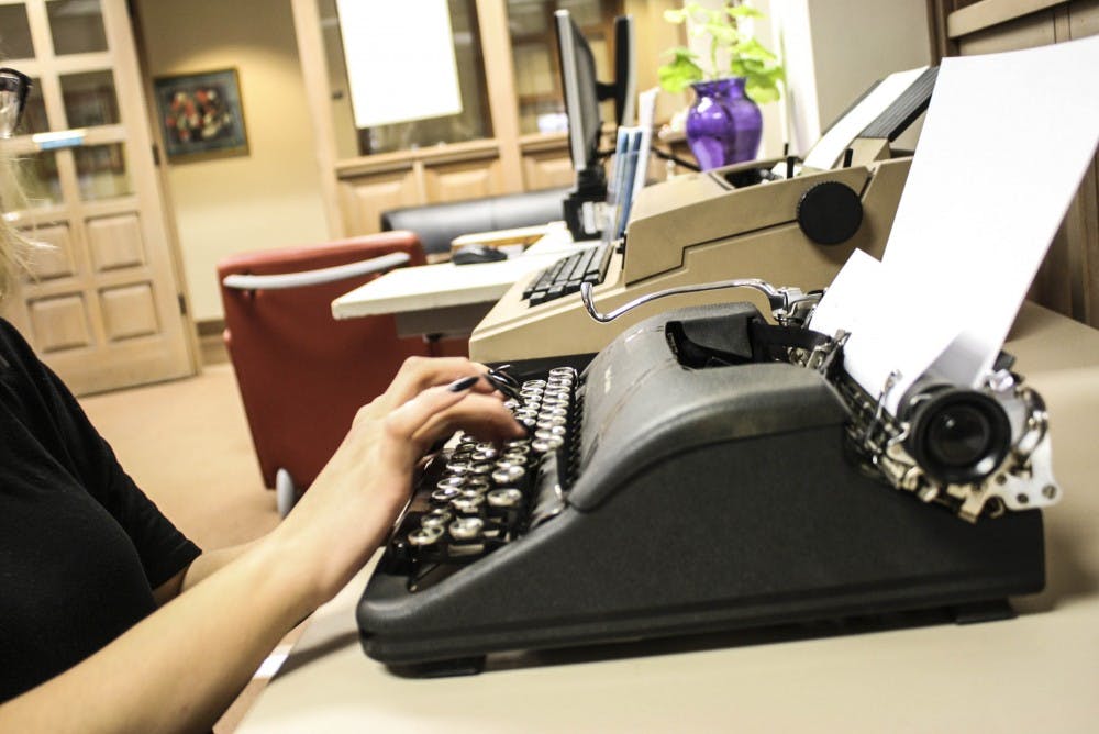 A UNM student partakes in the typewriter writing challenge in the Indigenous Library on November 29, 2017.